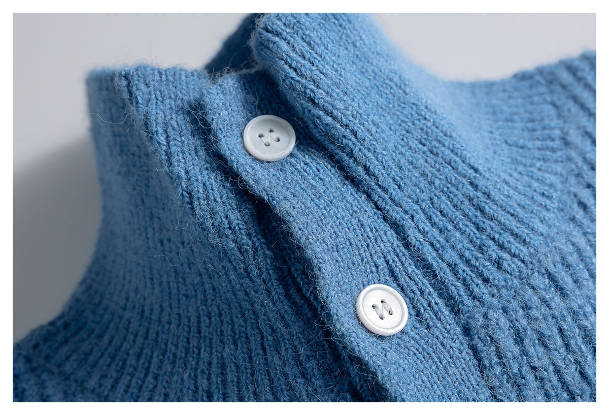 Close-up of the blue vest's ribbed knit texture and two white buttons on the collar placket.