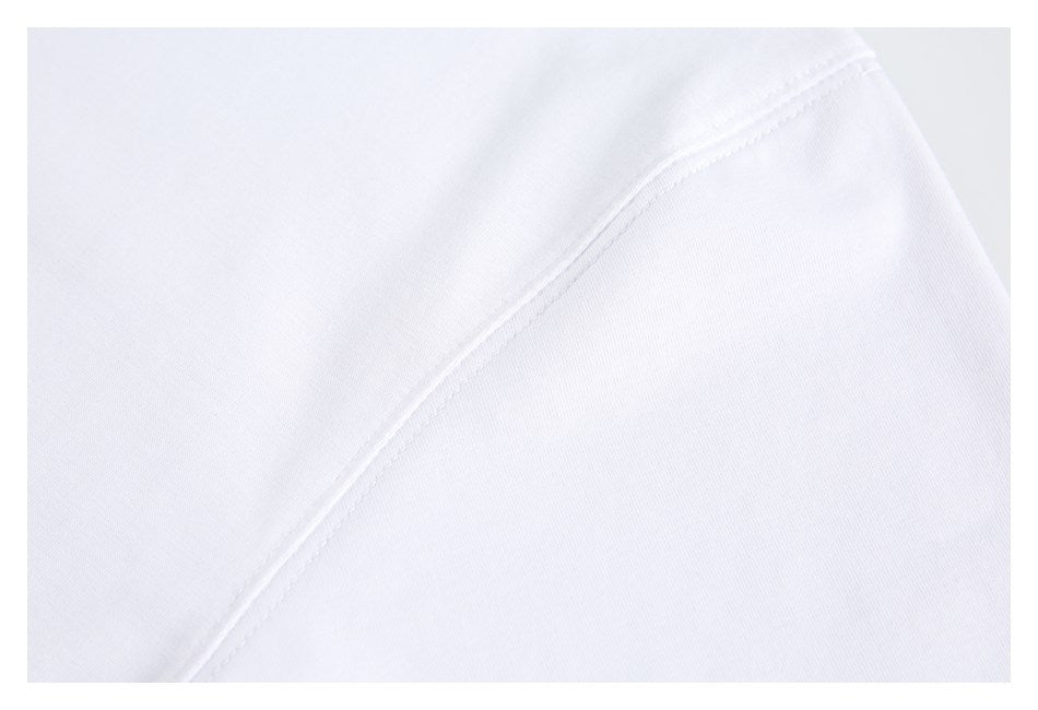 Close-up of white fabric with a curved stitched seam.