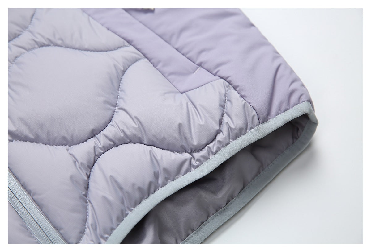 Close-up of curved quilting and gray binding along the edge of a lavender garment.
