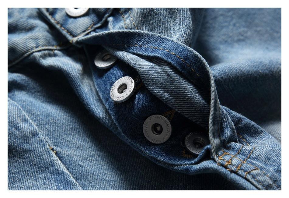 Close-up of the shorts' metal buttons and blue denim fly fastening.