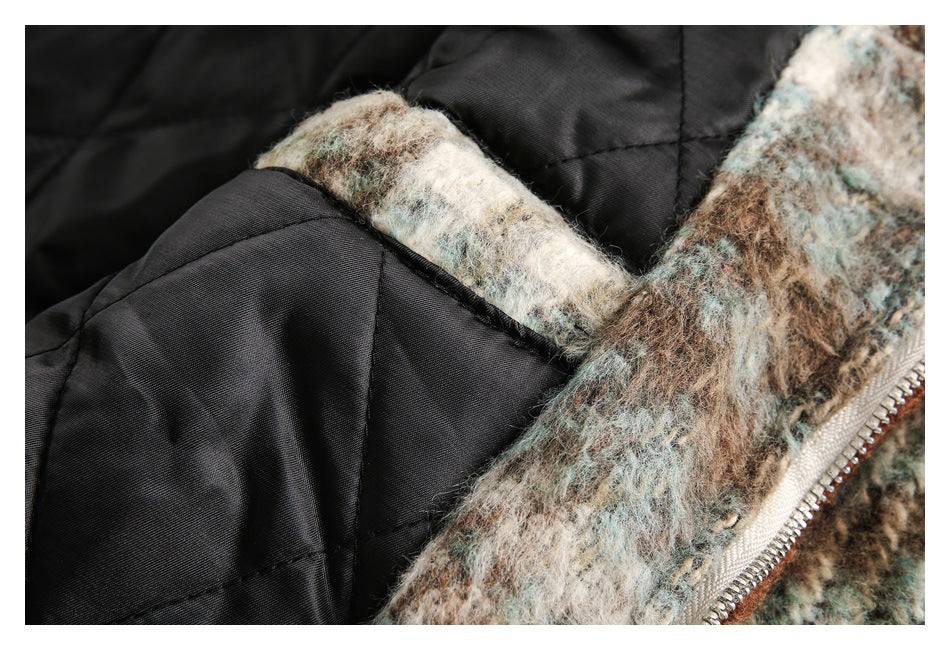 Close-up of the coat's black quilted lining beside its patterned outer fabric and metal zipper.