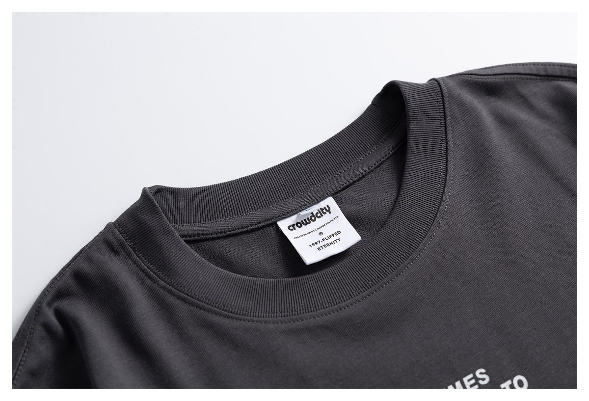 Close-up of a charcoal T-shirt's ribbed crew neck and sewn-in white brand label.
