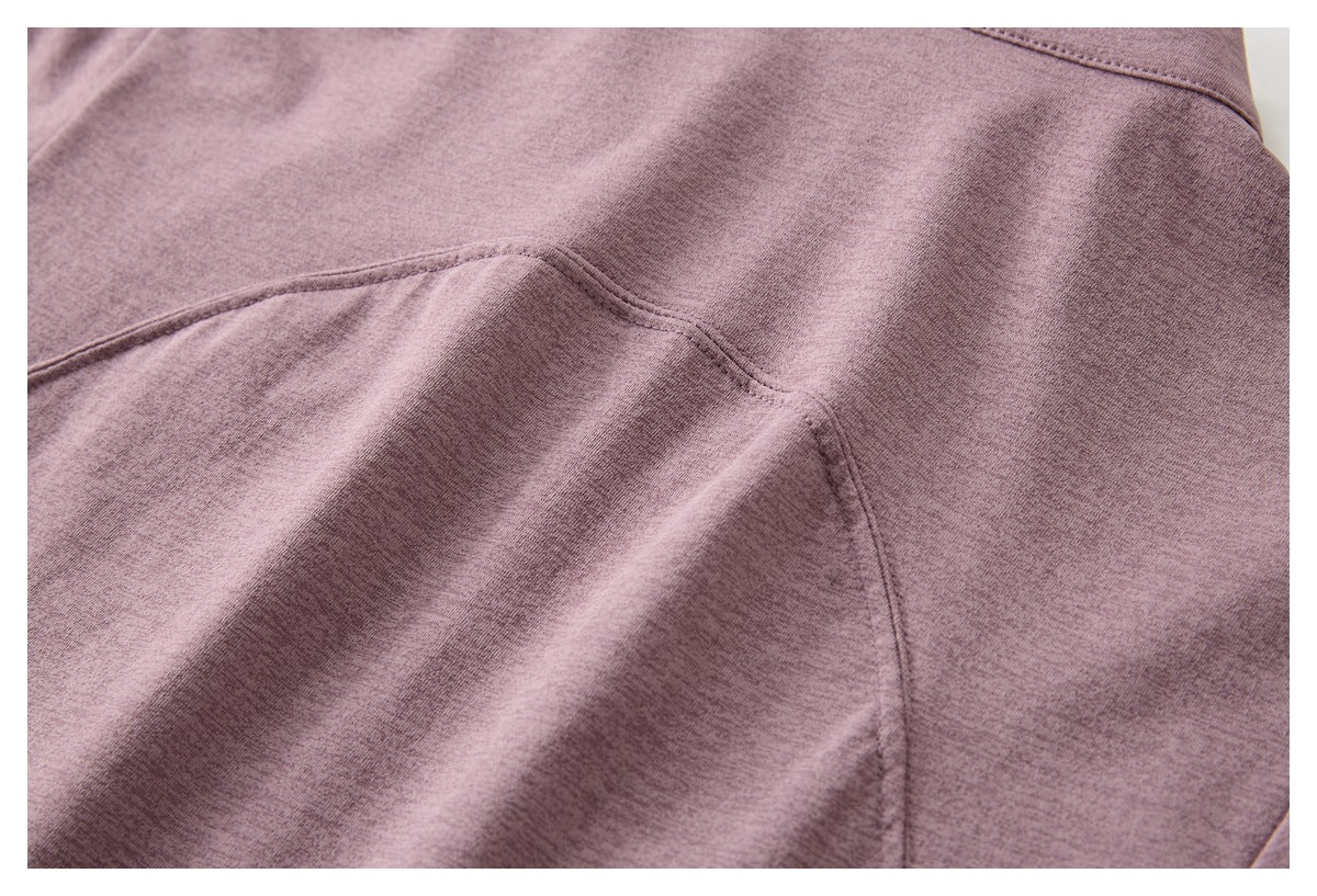 Close-up of curved panel seams on mauve heather fabric.
