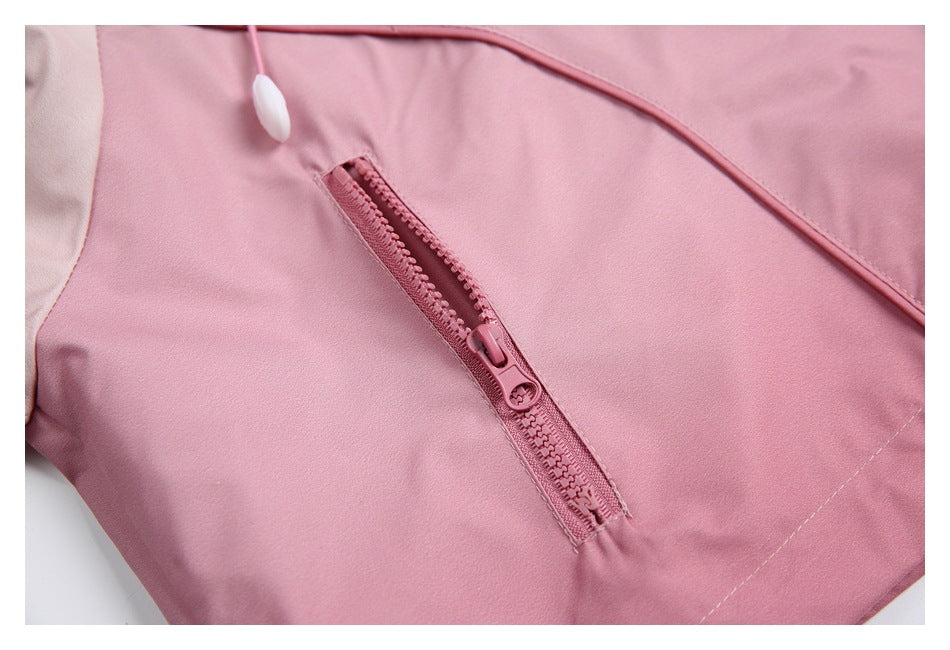 Close-up of a dusty pink jacket showing a diagonal zip pocket and a cord detail.