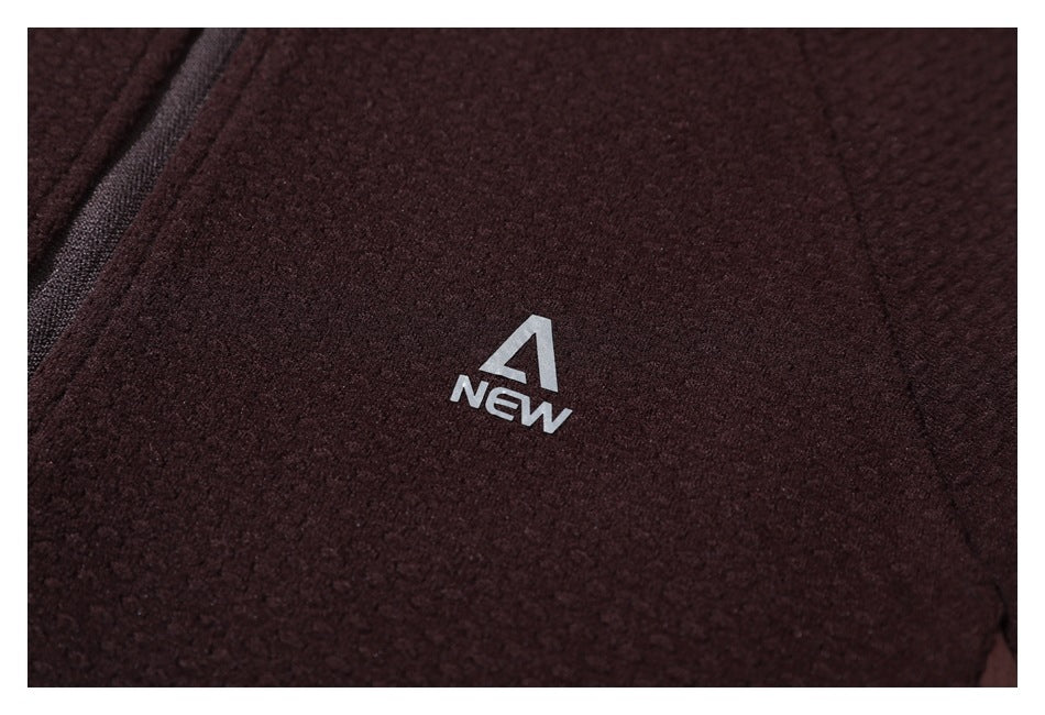 Close-up of a dark burgundy textured jacket with a small silver A NEW chest logo.