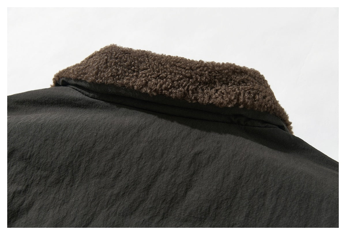 Close-up of a dark jacket collar with thick brown curly fleece lining.