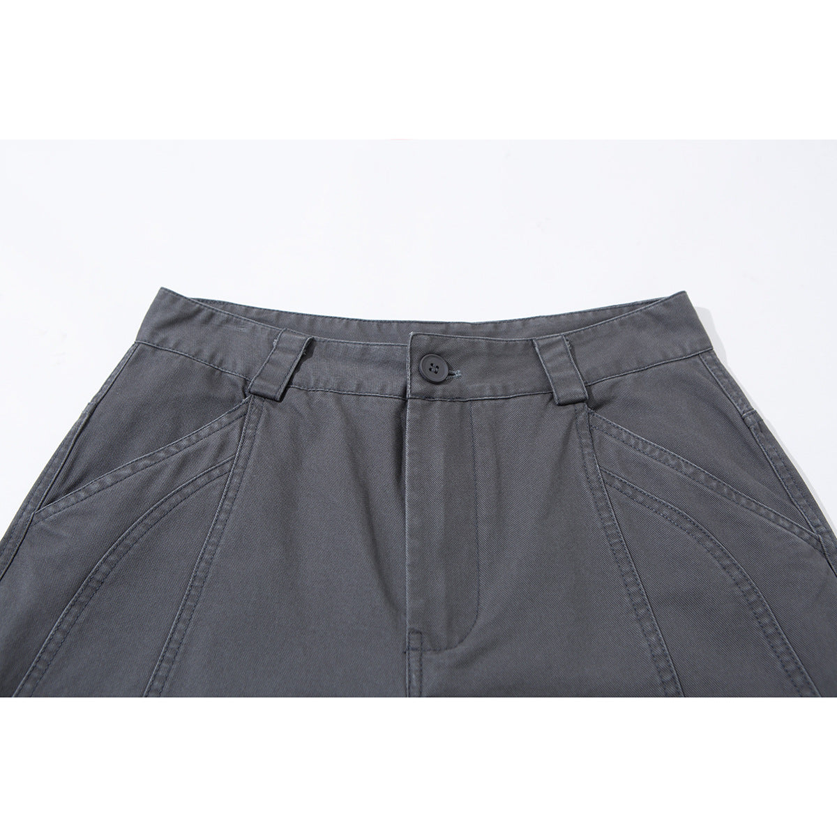 Close-up of charcoal-gray trousers showing the buttoned waistband, belt loops, fly, and curved front seams.