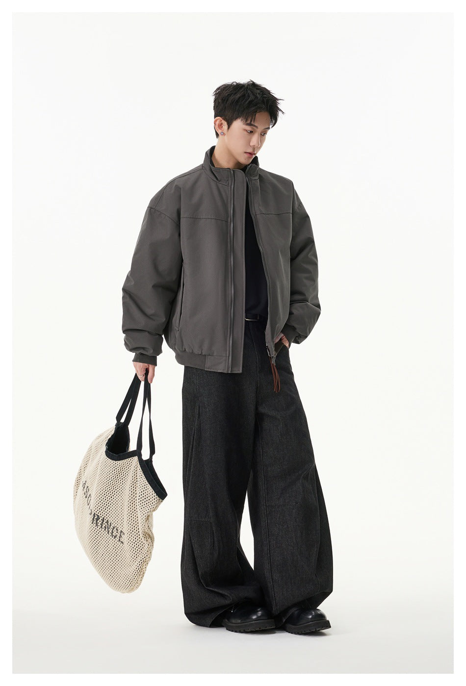 Full-length view of a model wearing the charcoal gray jacket with dark wide-leg pants.