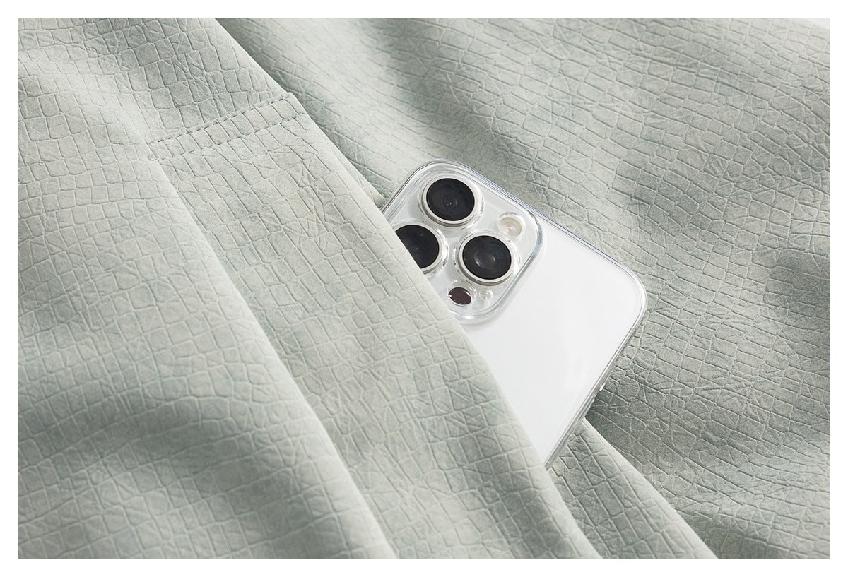 Close-up of the jacket's textured fabric and a white phone tucked into a pocket.