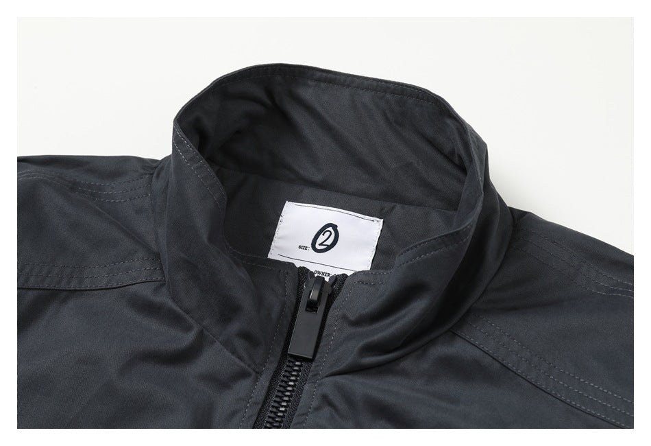 Close-up of a dark charcoal jacket collar, front zipper, and sewn size label.