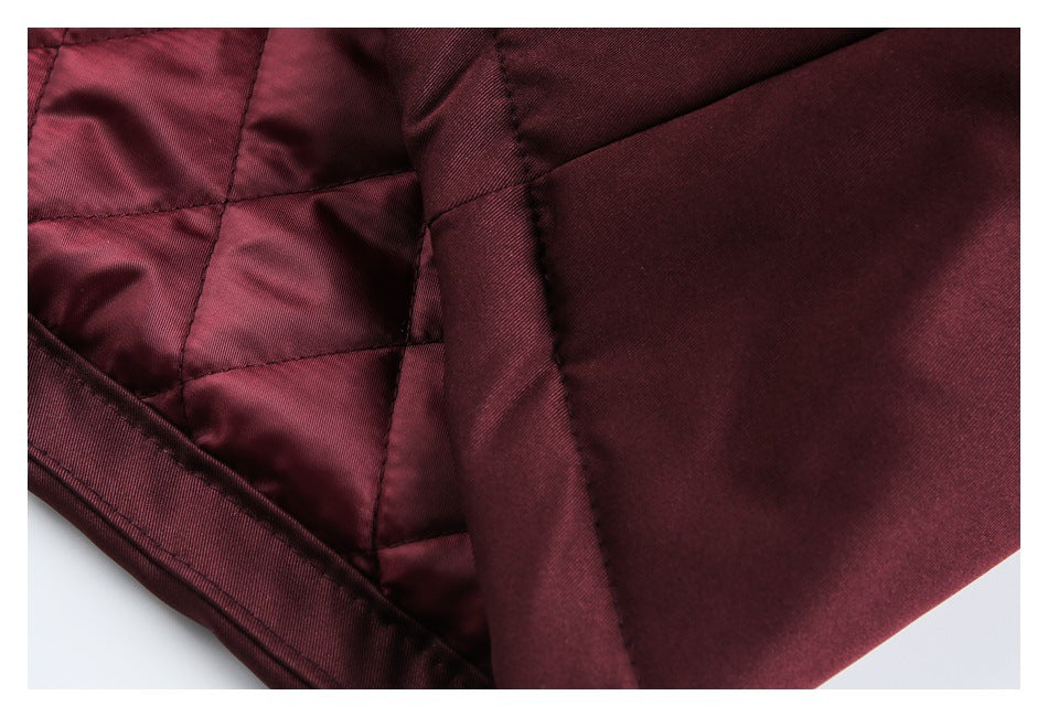 Close-up of burgundy jacket interior showing quilted lining and stitched seams.