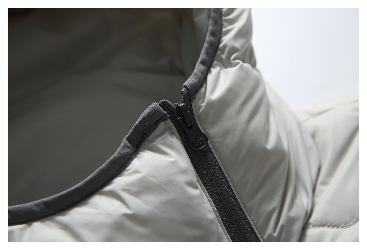 Close-up of the light gray jacket's hood opening, dark trim, and black zipper.