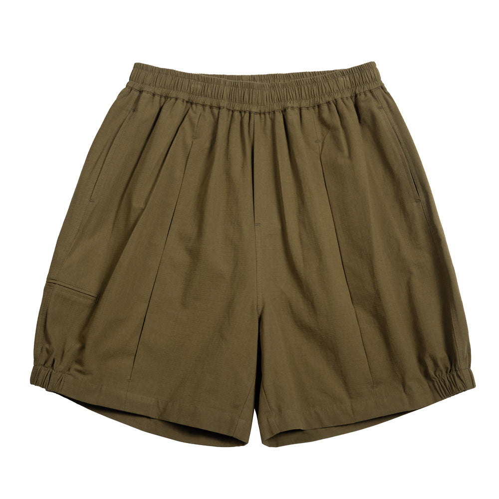 Olive green elastic-waist pleated knee-length shorts with a side thigh pocket and elasticized hems, flat lay front view