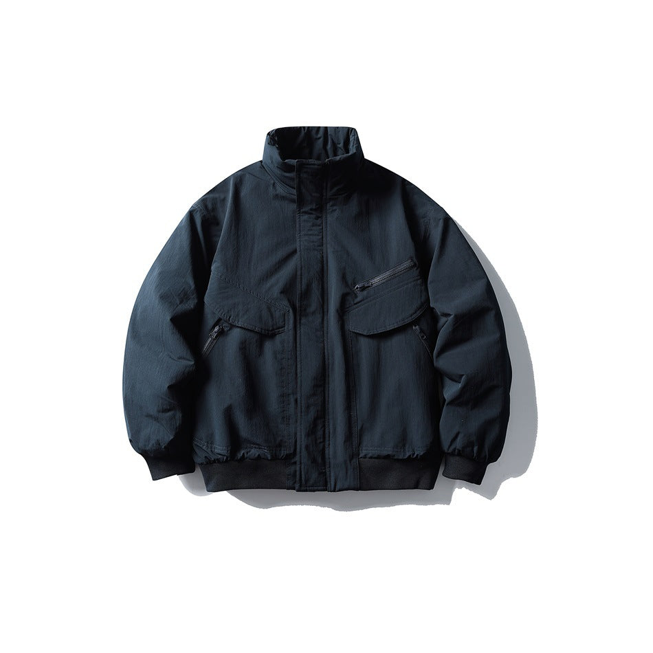 Navy bomber-style jacket with stand collar, flap pockets, zip chest pocket and black ribbed cuffs and hem, front view