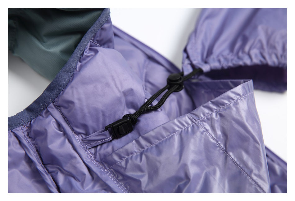 Close-up of a black elastic drawcord and toggle on a lavender padded garment beside sage-green lining.