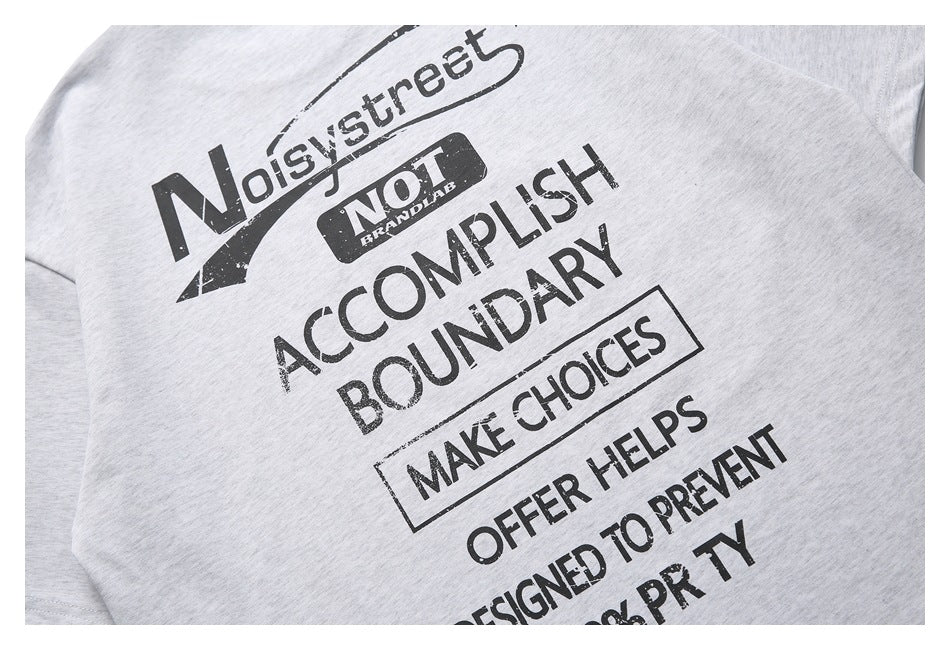 Close-up of the black text graphic printed on a light gray heathered garment.