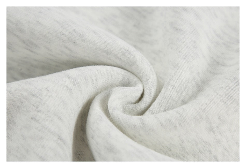Close-up of light heather-gray fabric gathered into a soft fold.