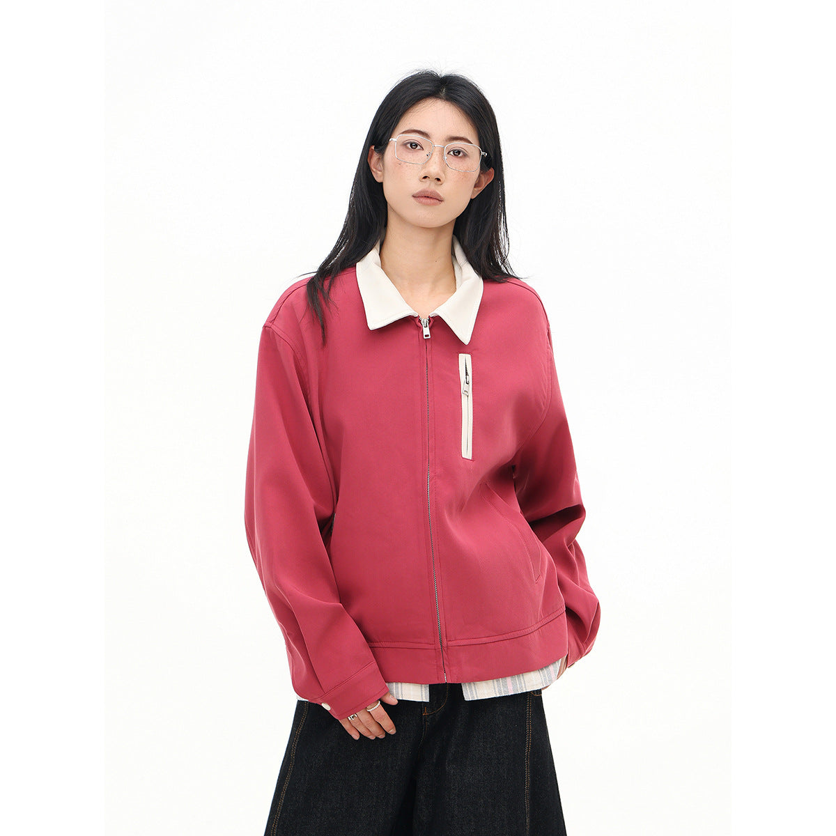 Model wearing a rose-pink zip-front jacket with a cream collar and vertical chest pocket zipper.