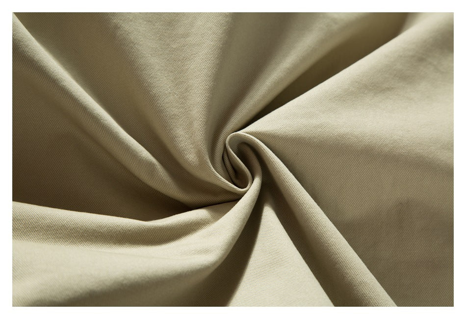 Close-up of beige twill fabric draped into soft folds.