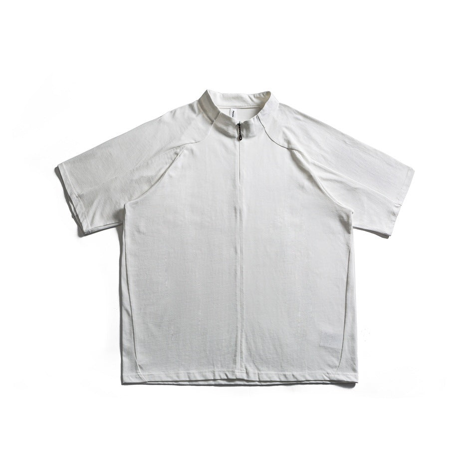 Front view of a white short-sleeve top with raglan seams, a stand collar, and a short front zipper.
