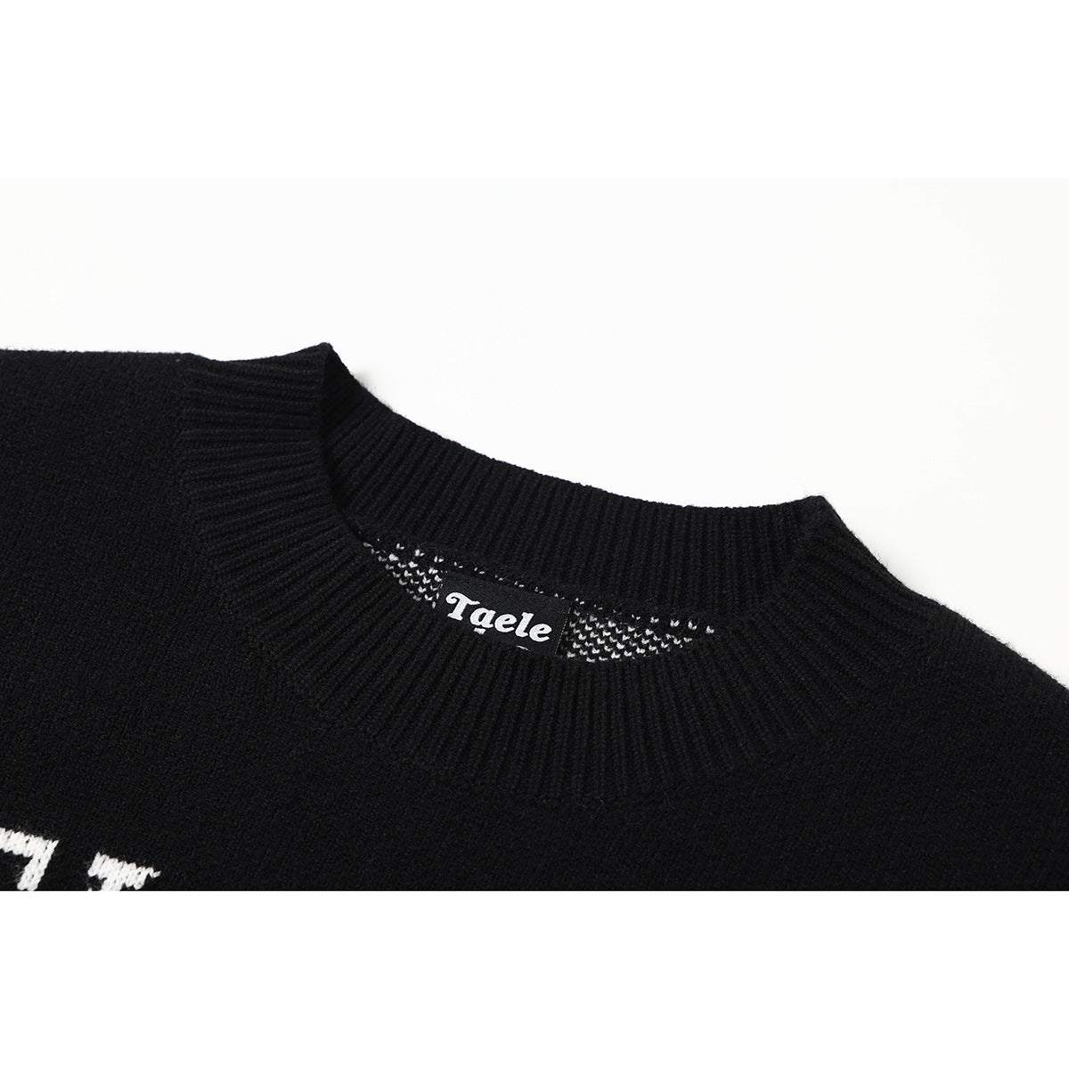 Close-up of a black sweater's ribbed crew neck and inner label.