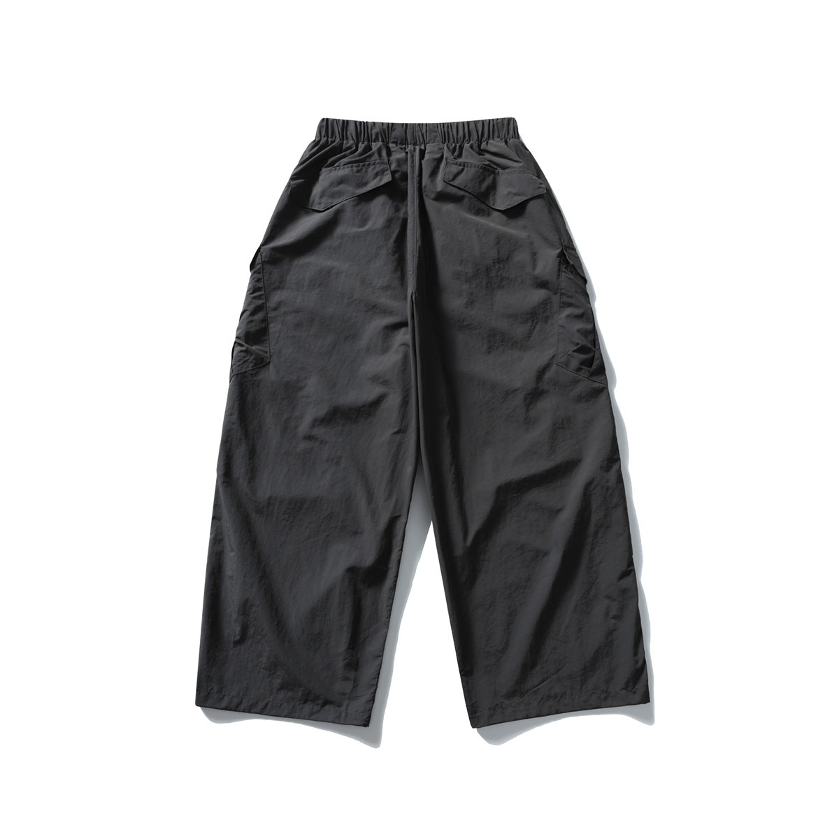 Back view of dark charcoal Volcanic Ash wide-leg cargo pants with flap back pockets and side pockets