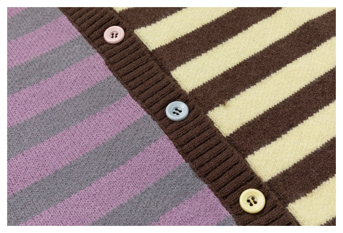 Close-up of a striped knit cardigan with a dark brown ribbed button placket and pink, blue-gray, and cream buttons.