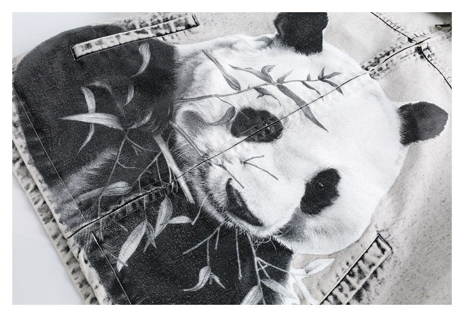 Close-up of a large black-and-white panda graphic with bamboo on the jacket's acid-wash denim.