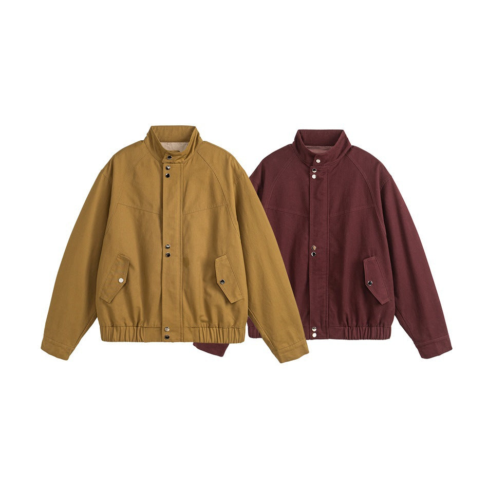 Two jackets shown together: one ochre tan and one burgundy, both with snap fronts, stand collars, and angled pockets.