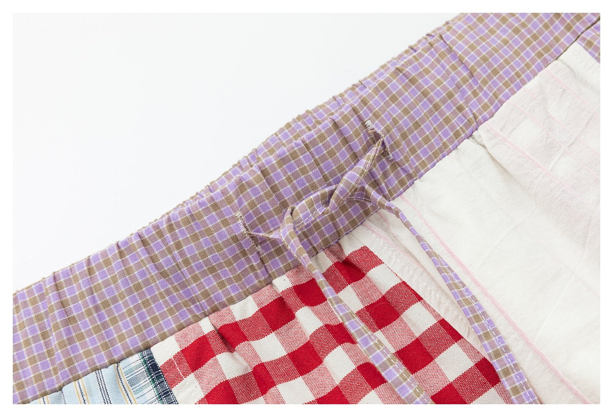 Close-up of the lavender-check waistband and drawstring above red gingham and white panels.