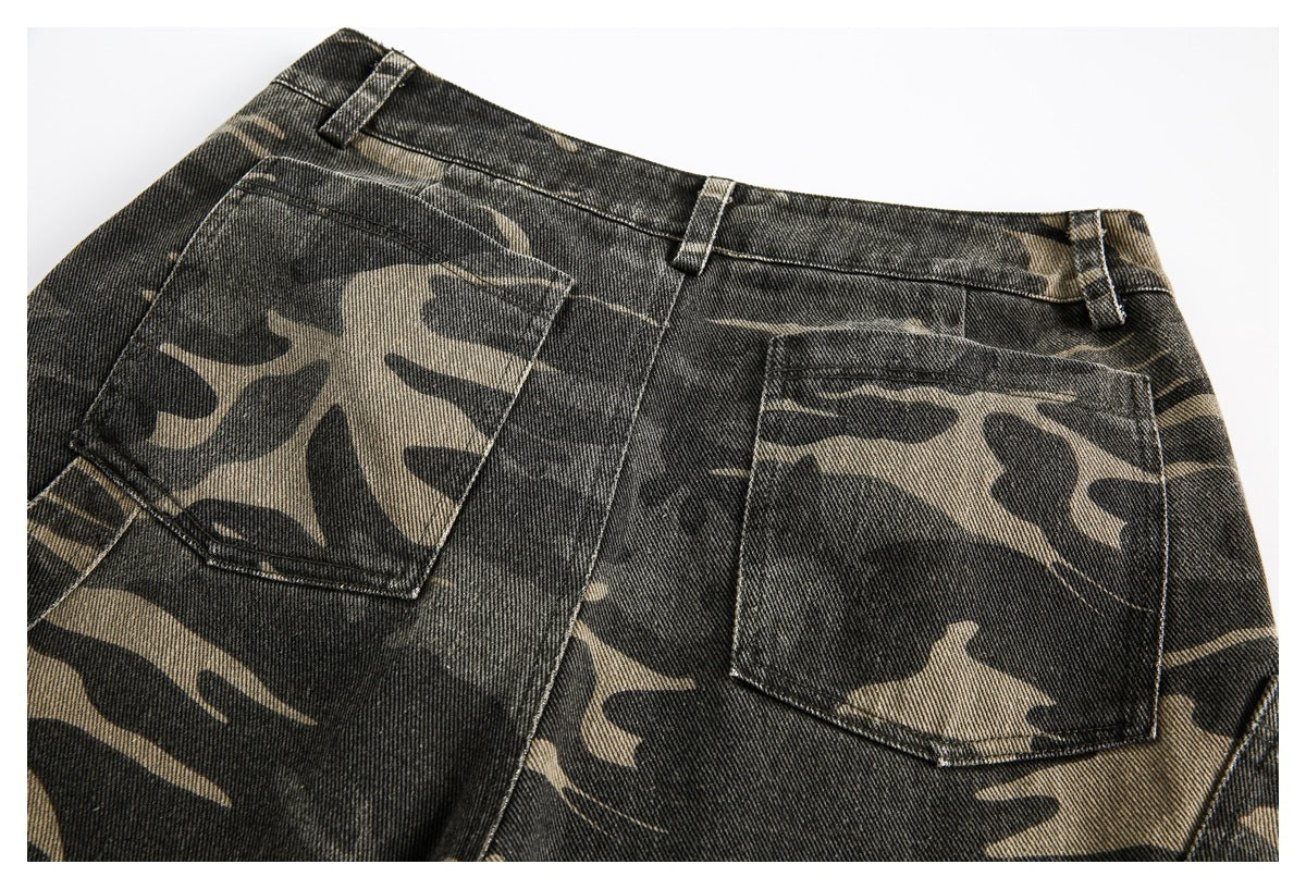 Close-up of the back of black and tan camouflage jeans, showing the waistband, belt loops, and two pockets.