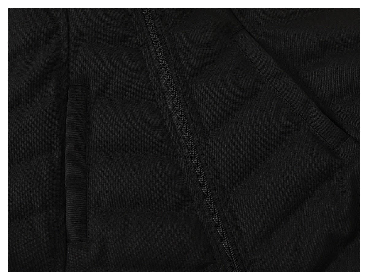 Close-up of a black jacket front showing a diagonal zipper and two pocket openings.