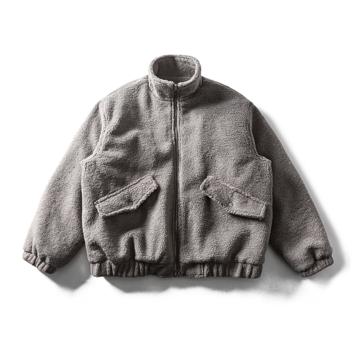 Dark gray teddy-texture stand-collar zip jacket with two snap-flap pockets and elastic hem, flat lay front view