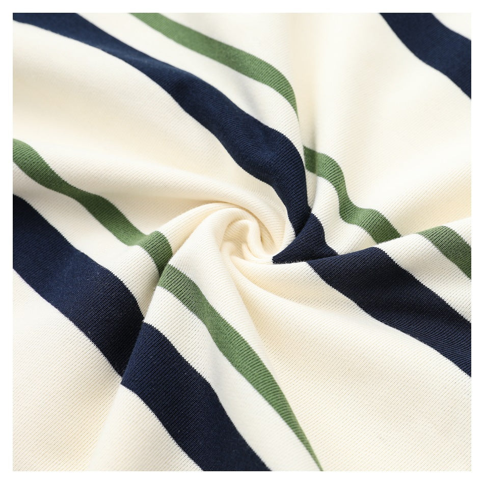 Close-up of draped cream knit fabric with broad navy and narrow muted green stripes.