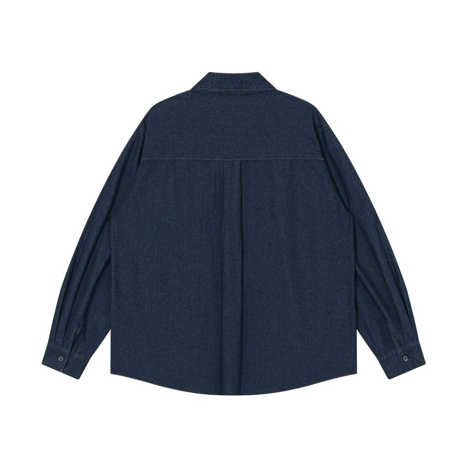 Back view of a dark blue long-sleeve button-up shirt with a yoke seam and center pleat.