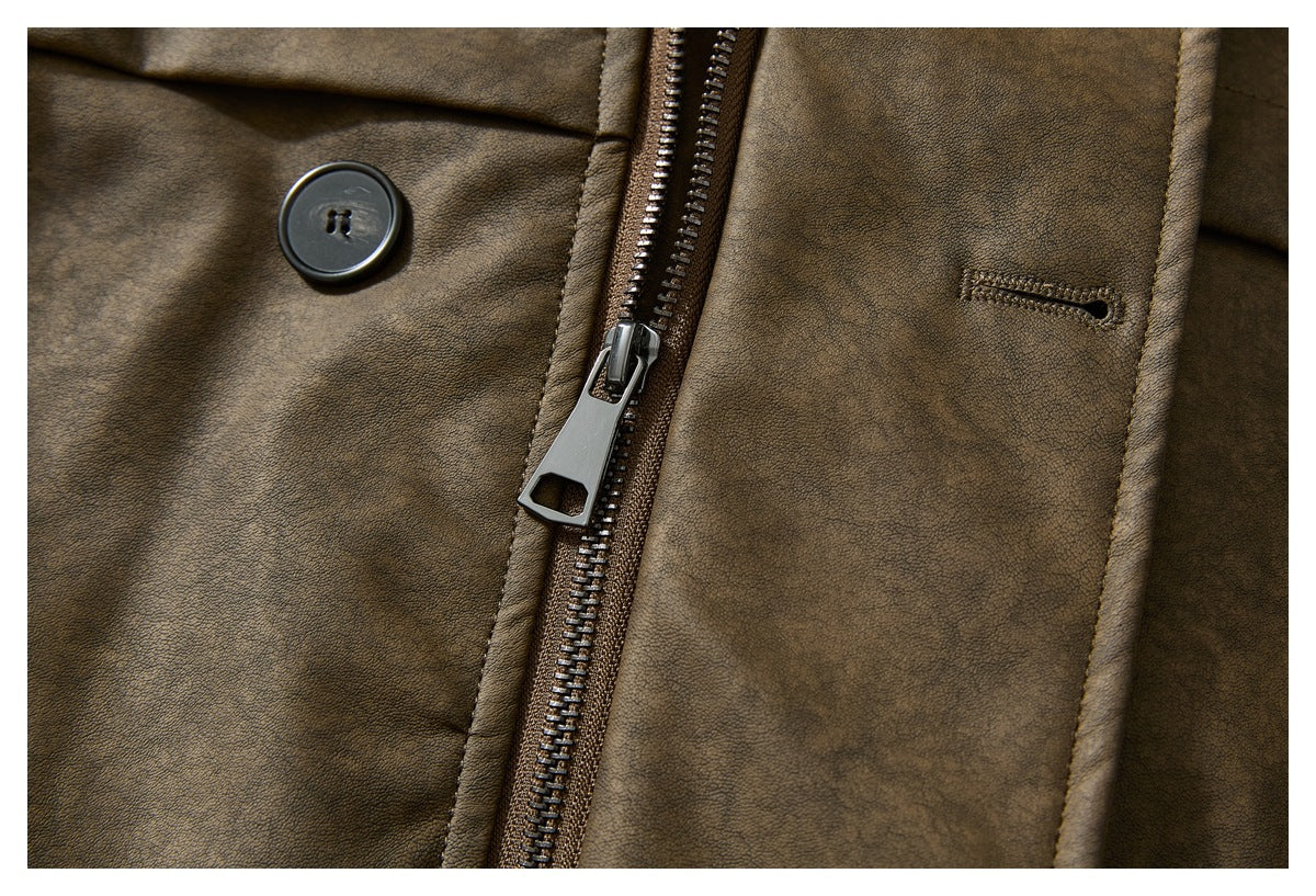 Close-up of a brown jacket front showing its zipper, button, and buttonhole.