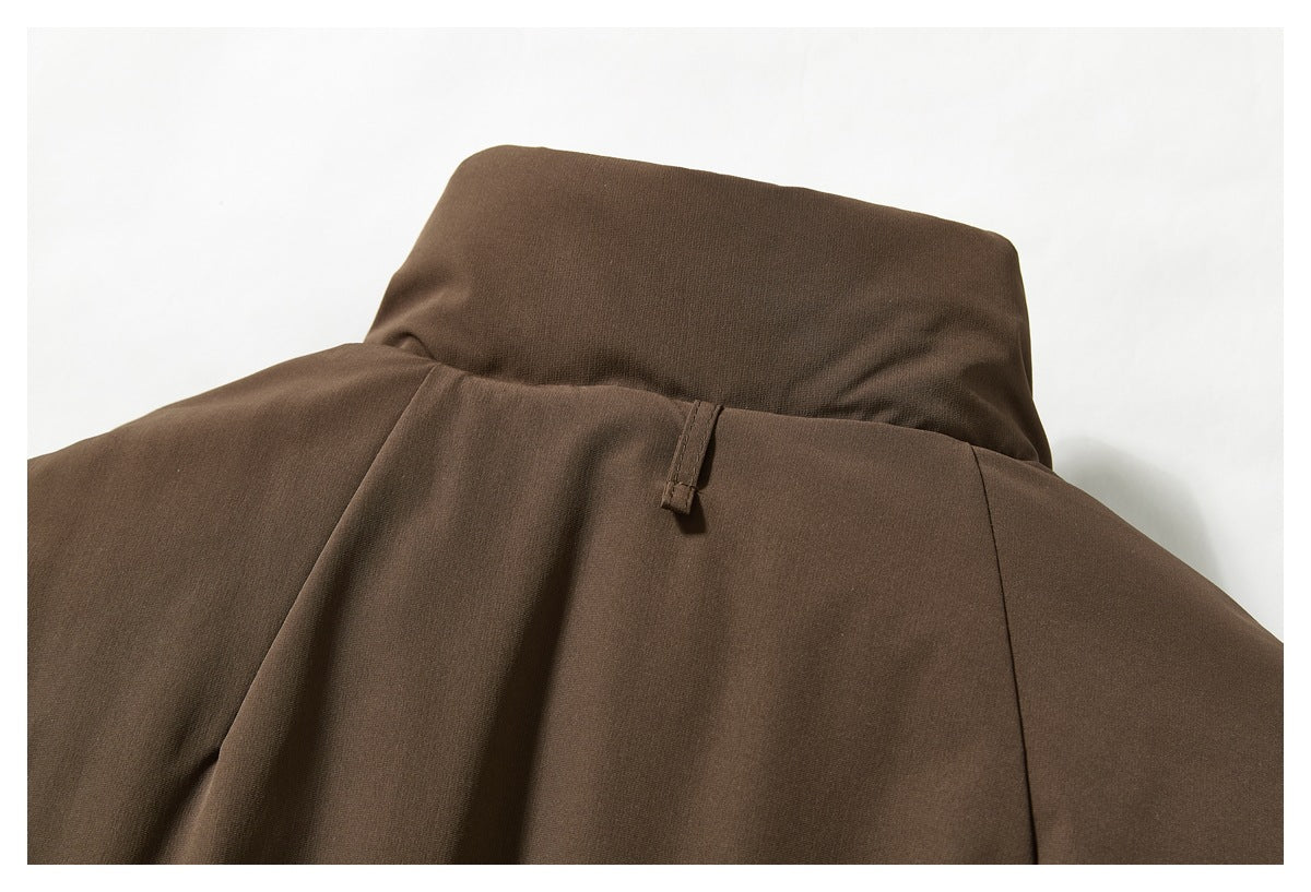 Close-up of a brown jacket's upper back and collar area, with a small hanging loop.
