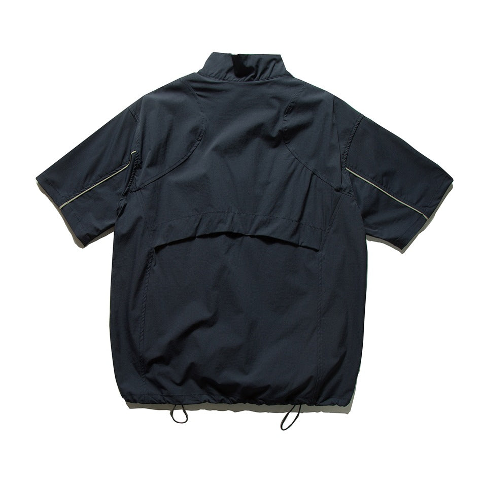 Back view of a navy short-sleeve pullover with a raised collar, curved back panel, contrast sleeve piping, and adjustable