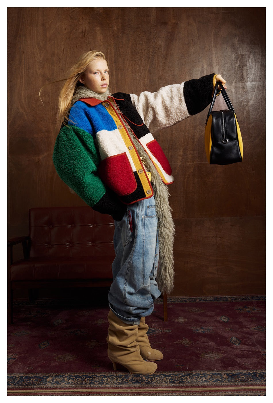 Full-length view of a model in a multicolor fleece jacket, loose jeans and tan boots.