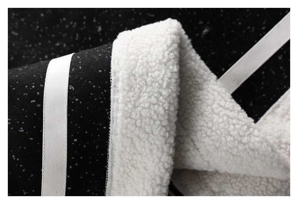 Close-up of black speckled fabric beside thick white textured lining and a white trim strip.