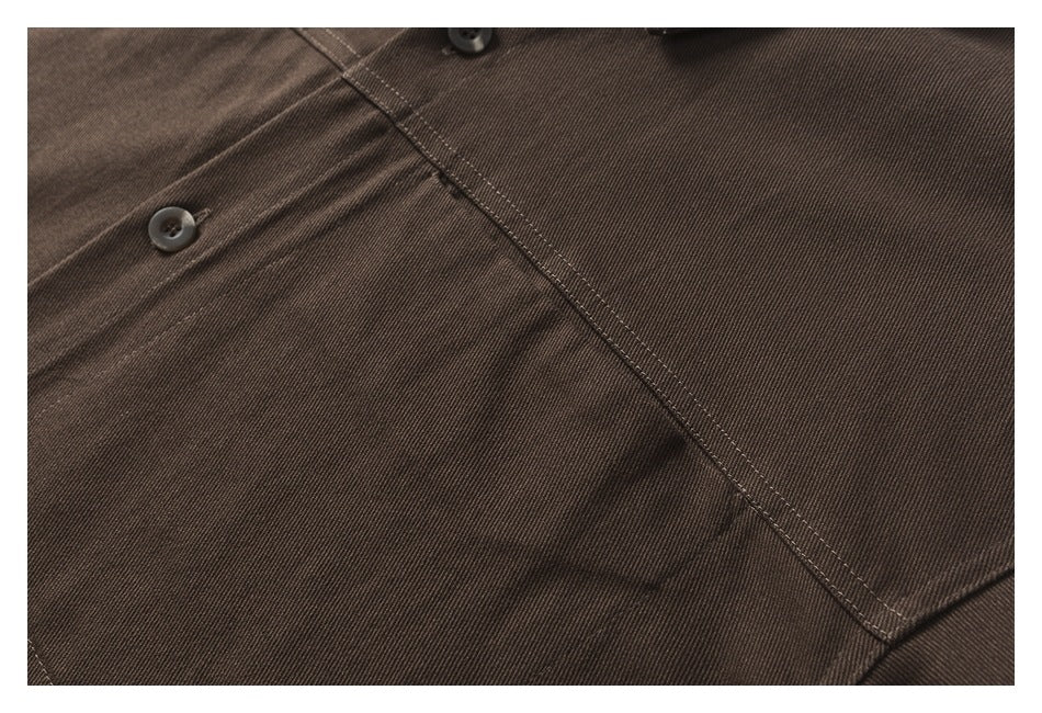 Close-up of the dark brown shirt's fabric, buttons, and intersecting seam stitching.