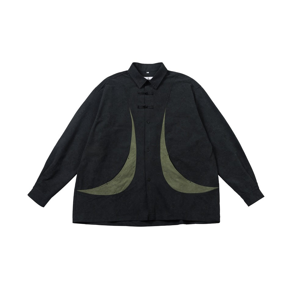 Black long-sleeve shirt with knot closures and curved green panels on the front, flat lay