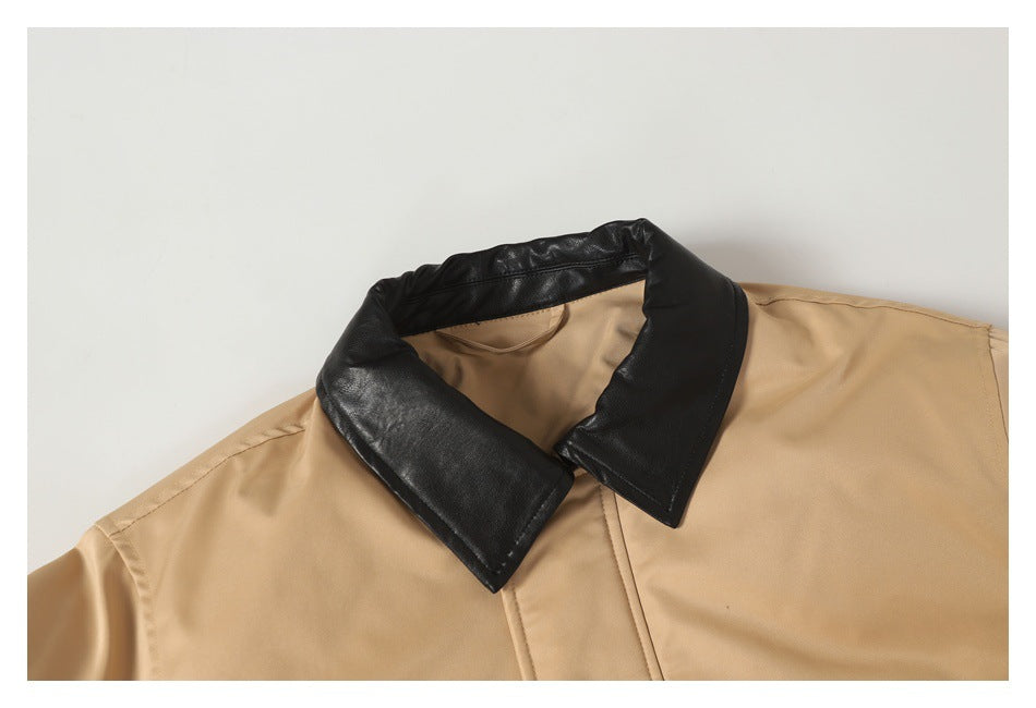 Close-up of a tan jacket with a contrasting black collar and visible front seam.