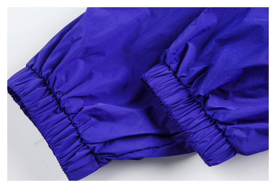 Close-up of gathered elastic cuffs on a royal blue garment.