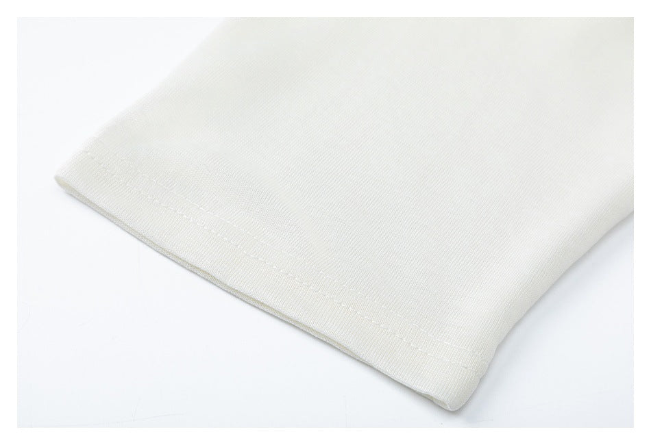 Close-up of an ivory shirt sleeve cuff with a stitched hem.