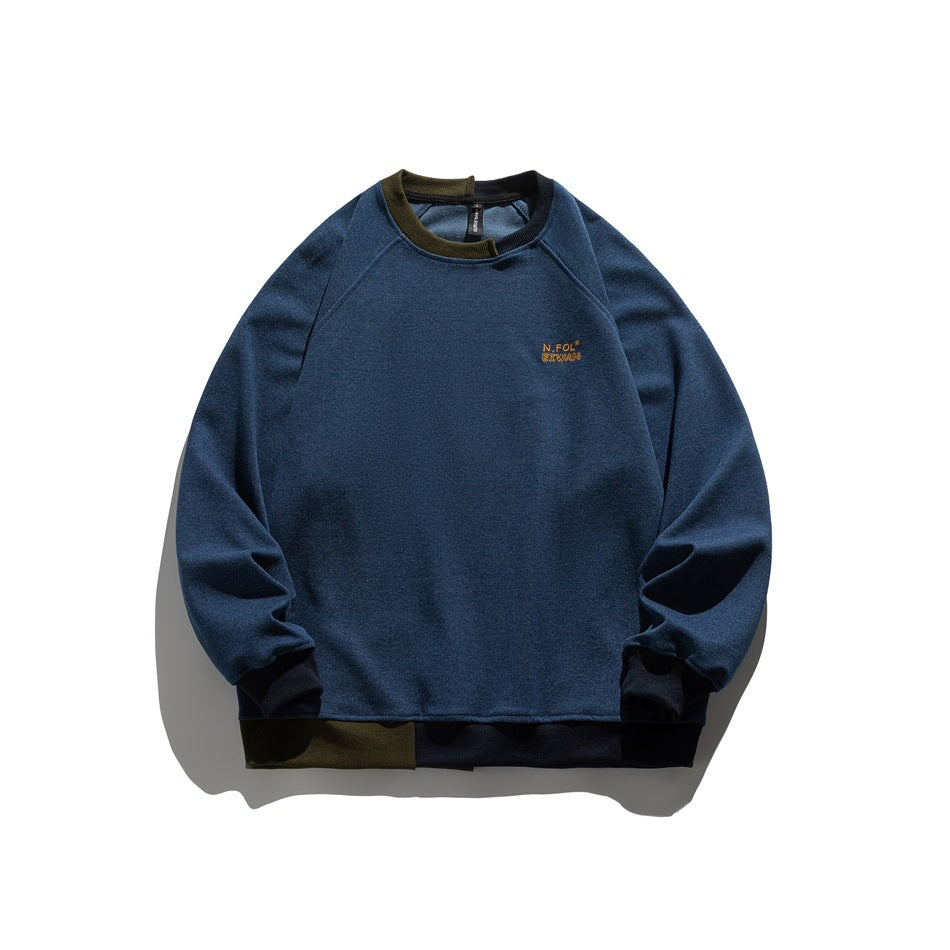 Blue crewneck raglan sweatshirt flat lay with olive and navy contrast ribbed collar, cuffs and hem