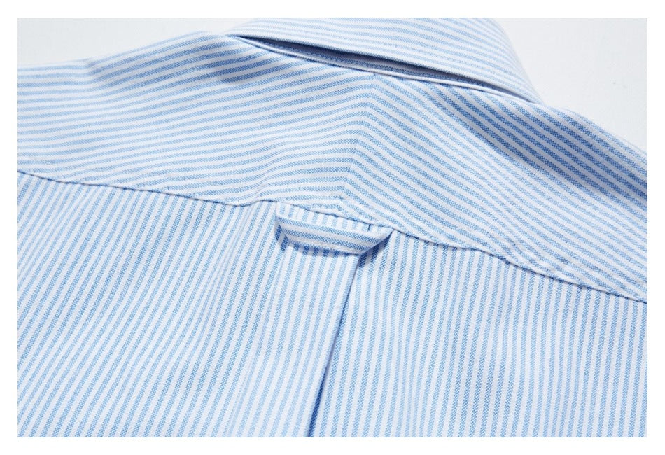 Close-up of the back yoke, collar, and hanging loop on a blue-and-white striped shirt.