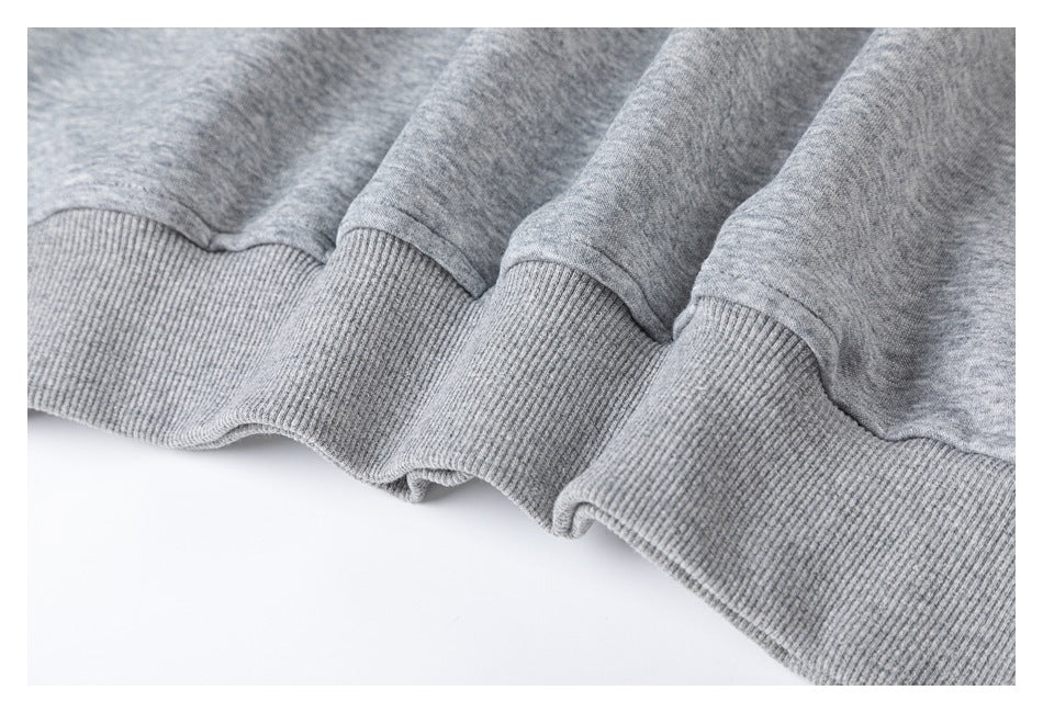 Close-up of the gray top's wide ribbed hem.