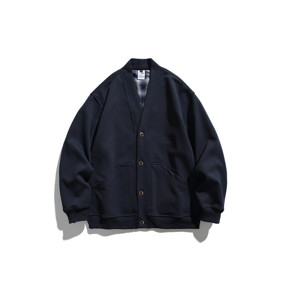 Navy V-neck button-front cardigan jacket with two front pockets and ribbed cuffs, flat lay with plaid inner collar