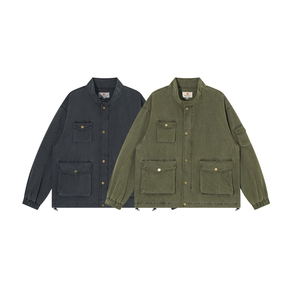 Two front views of a utility jacket in charcoal and olive, with stand collars and multiple flap pockets.